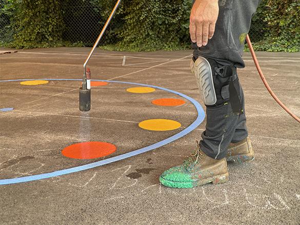 Colourful DecoMark chips being applied with a gas torch