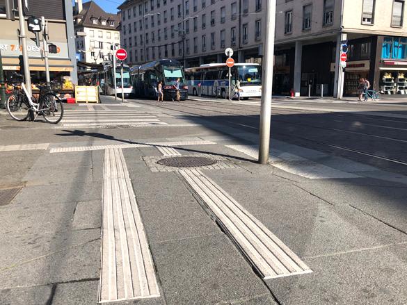 Tactile markings on walkway to signal visually impaired people it is safe to cross the road