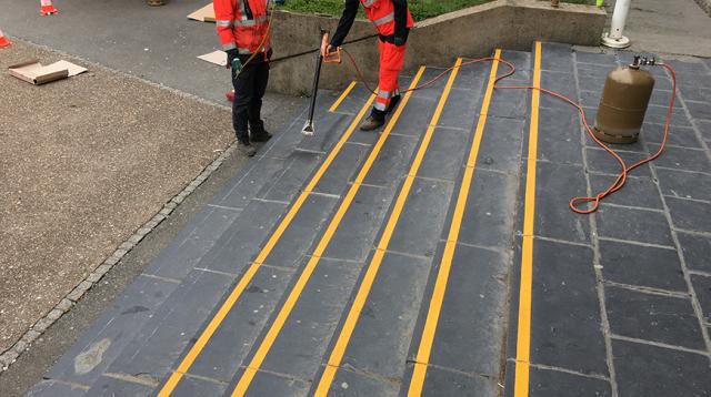 Application of yellow anti-slip T grip  lines on stairs